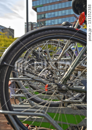 Large multi-level bicycle parking filled with bikes in a busy urban area. Large multi-level bicycle parking filled with bikes in a busy urban area. 131352388