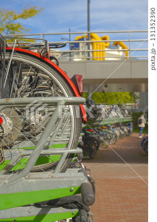 Large multi-level bicycle parking filled with bikes in a busy urban area. 131352390