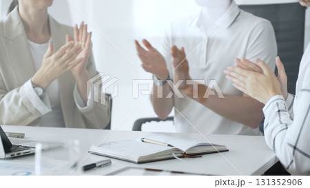 Business team applauding after achieving a goal during a productive meeting in a modern office environment, celebrating success and teamwork, close up Business team applauding after achieving a goal during a productive meeting in a modern office environment, celebrating success and teamwork, close up 131352906