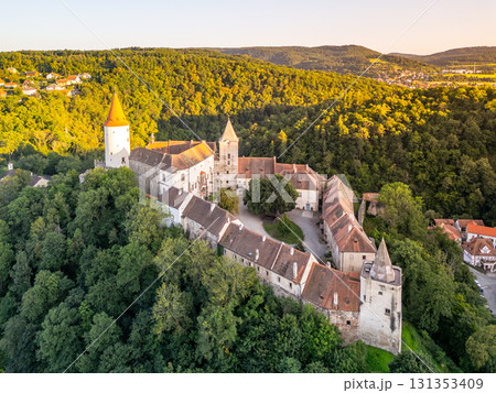 Discover the beauty of Krivoklat Castle nestled in lush greenery during a stunning sunset. This medieval structure in Czechia showcases its remarkable architecture and scenic surroundings. Discover the beauty of Krivoklat Castle nestled in lush greenery during a stunning sunset. This medieval structure in Czechia showcases its remarkable architecture and scenic surroundings. 131353409