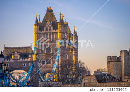 Morning light casts a warm glow on Tower Bridge as it spans the River Thames. The iconic structure stands tall against the clear sky, reflecting London's historic charm and beauty. Morning light casts a warm glow on Tower Bridge as it spans the River Thames. The iconic structure stands tall against the clear sky, reflecting London's historic charm and beauty. 131353465