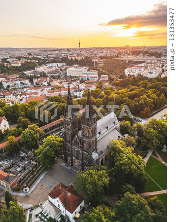 Morning light bathes Vysehrad Basilica of St. Peter and St. Paul in a golden glow, highlighting its gothic architecture amidst the lush scenery of Prague. A tranquil start to the day unfolds. Morning light bathes Vysehrad Basilica of St. Peter and St. Paul in a golden glow, highlighting its gothic architecture amidst the lush scenery of Prague. A tranquil start to the day unfolds. 131353477