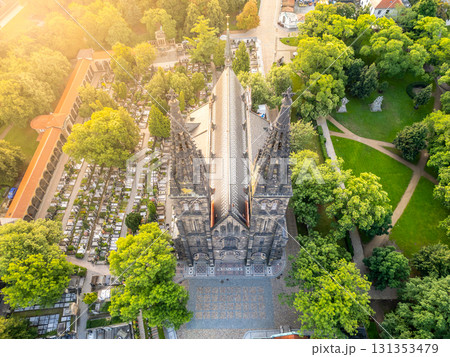 St. Peter and St. Paul Basilica stands majestically in Vysehrad, Prague, bathed in soft morning light. The serene landscape showcases nearby greenery and cemetery, adding to the peaceful atmosphere. St. Peter and St. Paul Basilica stands majestically in Vysehrad, Prague, bathed in soft morning light. The serene landscape showcases nearby greenery and cemetery, adding to the peaceful atmosphere. 131353479