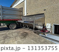 Grapes are transferring from the back of a large trailer into industrial winery equipment, beginning the process of pressing and winemaking during the autumn harvest season 131353755