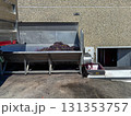 Freshly harvested red grapes pouring into a stainless steel destemmercrusher in a modern, large scale winery, beginning industrial wine production and juice extraction 131353757