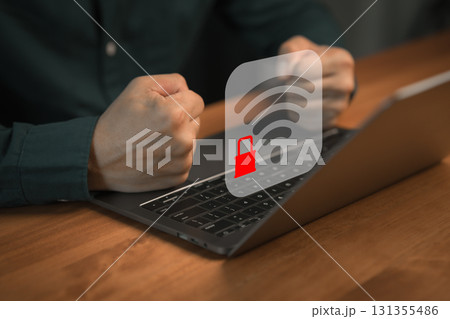 Frustrated person with fists clenched in front of laptop showing locked Wi-Fi icon, representing internet connection problems, network security and online access restrictions. Frustrated person with fists clenched in front of laptop showing locked Wi-Fi icon, representing internet connection problems, network security and online access restrictions. 131355486