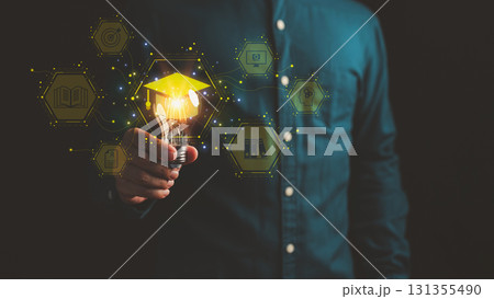 Person holding glowing light bulb with graduation cap icon and education symbols, representing innovative learning, knowledge development, beyond schooling and creative ideas in modern education. 131355490