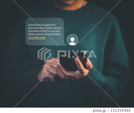 Person holding smartphone with phishing scam message alert about bank login, representing online fraud, cybersecurity threats, identity theft, and internet safety awareness. Person holding smartphone with phishing scam message alert about bank login, representing online fraud, cybersecurity threats, identity theft, and internet safety awareness. 131355491