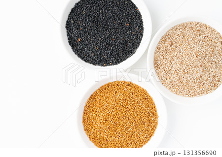 白背景にお皿に入れて並べた黒ごまと白ごまと金ごま(生ごま) 白背景にお皿に入れて並べた黒ごまと白ごまと金ごま(生ごま) 131356690