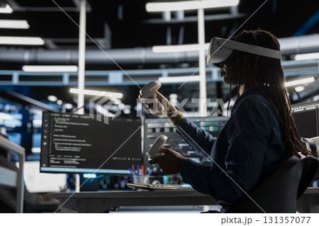 Data center engineer wearing VR equipment using artificial intelligence neural networks technology. Server farm employee using virtual reality headset and AI programming language to configure hardware 131357077