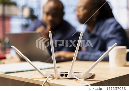 African American man and woman checking with the internet provider for support, discussing possible solutions to their ongoing Wi Fi connectivity issues. Troubleshooting the errors. 131357088