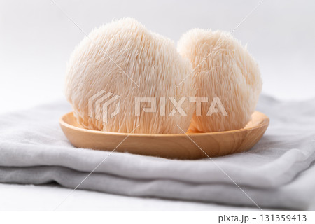 Lion's Mane mushroom or Yamabushitake mushroom on wooden plate Lion's Mane mushroom or Yamabushitake mushroom on wooden plate 131359413