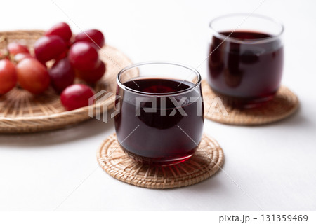 Red grape juice in glass and fresh grapes fruit on white background, Healthy drink 131359469