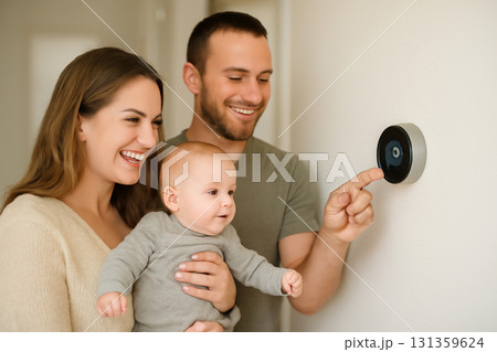 AI generated photo of a young family with a baby installing a smart thermostat in their modern home. Joyful, warm, and modern living atmosphere capturing a happy family moment. AI generated photo of a young family with a baby installing a smart thermostat in their modern home. Joyful, warm, and modern living atmosphere capturing a happy family moment. 131359624