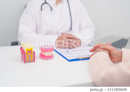 Elderly Patient consulting Dentist to Tooth disease, Senior Health Medical Diagnosis. Anatomy teeth model for Oral Teeth decay, Scrape off tartar. March Oral health, Dentist Day, False Teeth concept 131360609