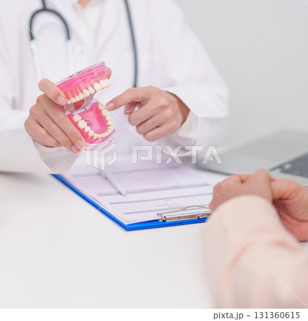 Elderly Patient consulting Dentist to Tooth disease, Senior Health Medical Diagnosis. Anatomy teeth model for Oral Teeth decay, Scrape off tartar. March Oral health, Dentist Day, False Teeth concept Elderly Patient consulting Dentist to Tooth disease, Senior Health Medical Diagnosis. Anatomy teeth model for Oral Teeth decay, Scrape off tartar. March Oral health, Dentist Day, False Teeth concept 131360615
