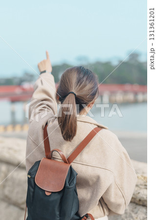 Woman tourist sightseeing Fukuura jima bridge or the bridge of romantic encounters for Fukuura Island at Matsushima Bay in Matsushima, Miyagi Prefecture, Tohoku, Japan. Landmark and famous Vacation 131361201
