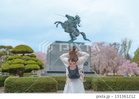 Woman tourist sightseeing Kajo Park Yamagata Castle Ruins with Sakura Cherry Blossom in Spring, happy traveler travel in Yamagata prefecture, Tohoku, Japan. famous Landmark for Travel and Vacation 131361212