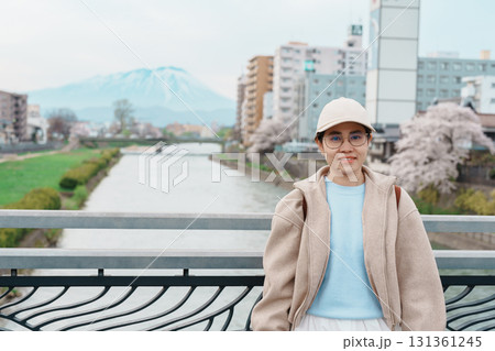 Woman tourist sightseeing Iwate mountain and Kitakami river with flowers in Spring, happy traveler travel in Morioka city, Iwate prefecture, Japan. famous Landmark Travel and Vacation destination Woman tourist sightseeing Iwate mountain and Kitakami river with flowers in Spring, happy traveler travel in Morioka city, Iwate prefecture, Japan. famous Landmark Travel and Vacation destination 131361245