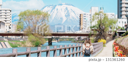 Woman tourist sightseeing Iwate mountain and Kitakami river with flowers in Spring, happy traveler travel in Morioka city, Iwate prefecture, Japan. famous Landmark Travel and Vacation destination Woman tourist sightseeing Iwate mountain and Kitakami river with flowers in Spring, happy traveler travel in Morioka city, Iwate prefecture, Japan. famous Landmark Travel and Vacation destination 131361260