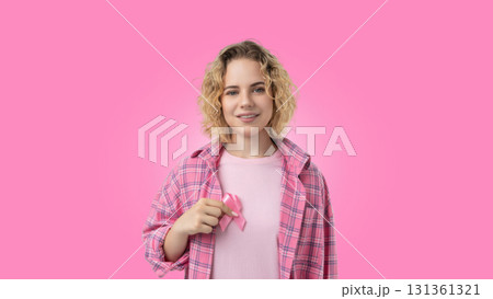 A young woman shows support for cancer awareness wearing pink 131361321