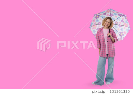 Smiling person with floral umbrella in bright scene Smiling person with floral umbrella in bright scene 131361330