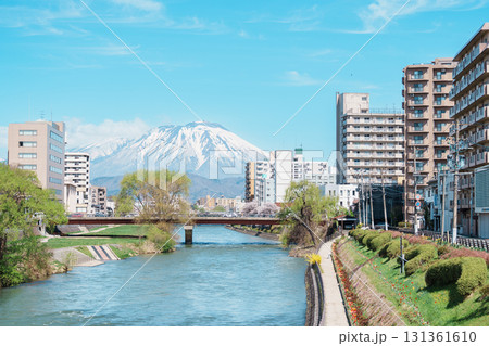 Beautiful Iwate mountain and Kitakami river with flowers blooming in Spring season, cityscape against blue sky in Morioka city, Iwate prefecture, Japan. famous Landmark Travel and Vacation destination Beautiful Iwate mountain and Kitakami river with flowers blooming in Spring season, cityscape against blue sky in Morioka city, Iwate prefecture, Japan. famous Landmark Travel and Vacation destination 131361610