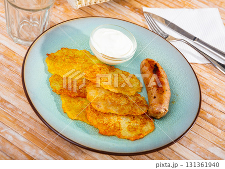 Potato pancakes with sausage and sour cream 131361940