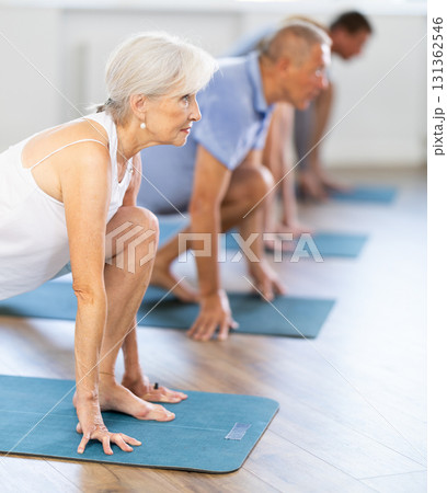 Elderly woman doing pilates in group Elderly woman doing pilates in group 131362546