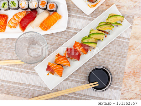 Variations of sashimi and sushi with soy sauce on table 131362557