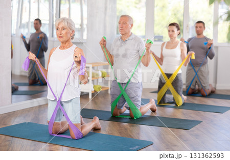 Elderly woman exercises with pilates band 131362593