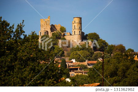 Ruins of Grimaud castle on hill dominating houses of village, France 131362902
