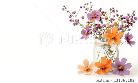 Vibrant Floral Arrangement in Glass Jar with Colorful Wildflowers on White Background 131363192
