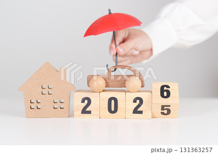 Happy New Year 2026 with red umbrella. Insurance, real estate, Home, car, loan, tax, investment, mortgage, financial, savings, protection and safety 131363257