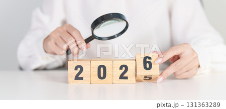 2025 end year to Happy New Year 2026 with magnifying glass and people. hiring, employee, recruitment, job, SEO and jobless concept 131363289