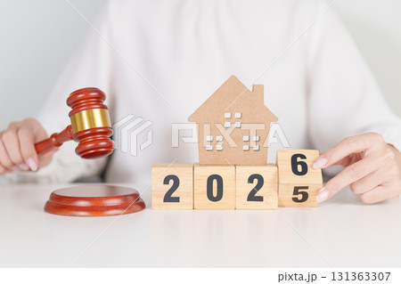 2025 end year to Happy New Year 2026 with small toy house model with gavel justice hammer on desk in courthouse. Real Estate Law, Home Insurance, property Tax, Auction and Bidding concepts 131363307