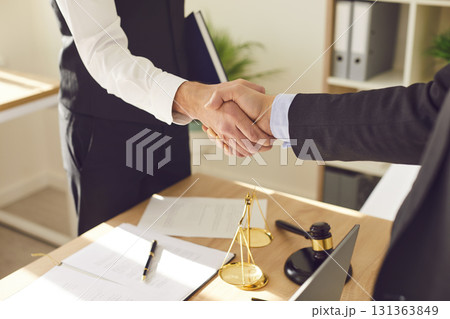 Lawyer and Client Handshake after Contract Signing in Office Lawyer and Client Handshake after Contract Signing in Office 131363849