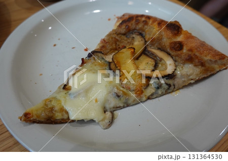 Hot and cheesy pizza slice with a crispy crust and savory toppings. A perfect mix of melty goodness and bold flavor for a satisfying comfort food favorite. 131364530