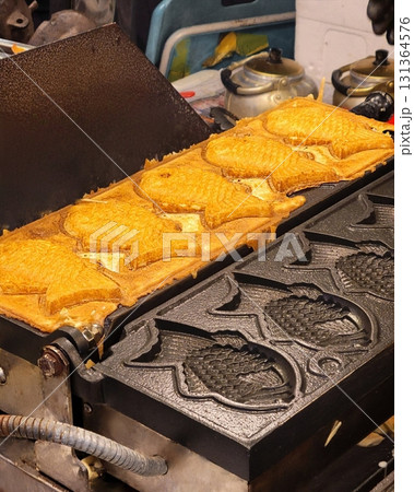 Bungeoppang, bungeo-ppang (Korean Fish Shaped Pastry), popular snack, cookies, sweet in winter streets of Korea. Bungeoppang - Korean traditional national food, dish, cuisine. Japanese taiyaki Bungeoppang, bungeo-ppang (Korean Fish Shaped Pastry), popular snack, cookies, sweet in winter streets of Korea. Bungeoppang - Korean traditional national food, dish, cuisine. Japanese taiyaki 131364576