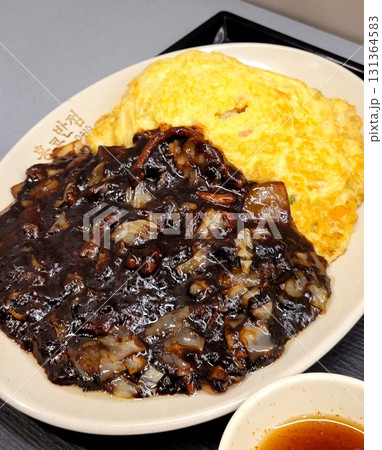 Classic jajangmyeon with thick noodles in a rich black bean sauce, garnished with sliced cucumber and sesame seeds. A beloved Korean-Chinese comfort dish, full of savory depth and flavor. Classic jajangmyeon with thick noodles in a rich black bean sauce, garnished with sliced cucumber and sesame seeds. A beloved Korean-Chinese comfort dish, full of savory depth and flavor. 131364583