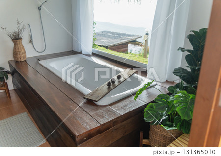 Tranquil Spa Bathroom with Scenic View Overlooking Water, Elegant Bathtub Design, Natural Decor and Relaxing Atmosphere for Wellness Retreat Tranquil Spa Bathroom with Scenic View Overlooking Water, Elegant Bathtub Design, Natural Decor and Relaxing Atmosphere for Wellness Retreat 131365010