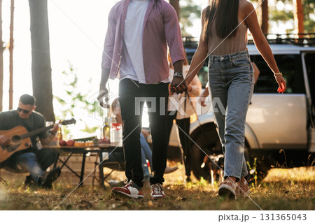Couple is walking forward. Group of friends are having fun together in the forest 131365043