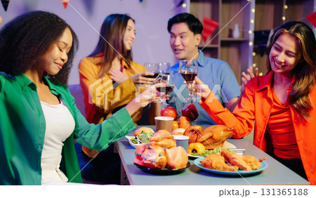 Celebration with friends enjoying food, drinks, and laughter at a lively house party. 131365188