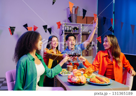 A diverse group of coworkers enjoying a casual office party or home with drinks, food, A diverse group of coworkers enjoying a casual office party or home with drinks, food, 131365189