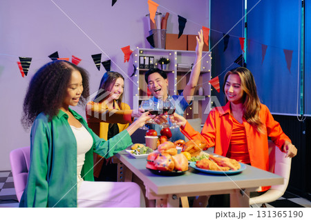 A diverse group of coworkers enjoying a casual office party or home with drinks, food, A diverse group of coworkers enjoying a casual office party or home with drinks, food, 131365190