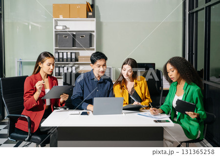 Multiracial group of young creative people in smart casual wear discussing business brainstorming meeting ideas design project. Multiracial group of young creative people in smart casual wear discussing business brainstorming meeting ideas design project. 131365258