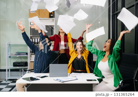 Diverse teams celebrating success in a lively office setting, capturing moments of joy, teamwork 131365264