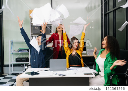 Diverse teams celebrating success in a lively office setting, capturing moments of joy, teamwork 131365266