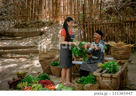 Engaging with a vibrant farmers market full of colorful produce and community spirit 131365447