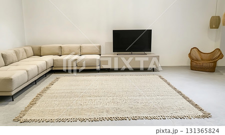 Living room with a white couch, a black television, and a wicker chair 131365824